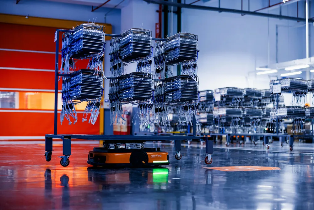 Automated industrial trolley moving goods inside a modern factory